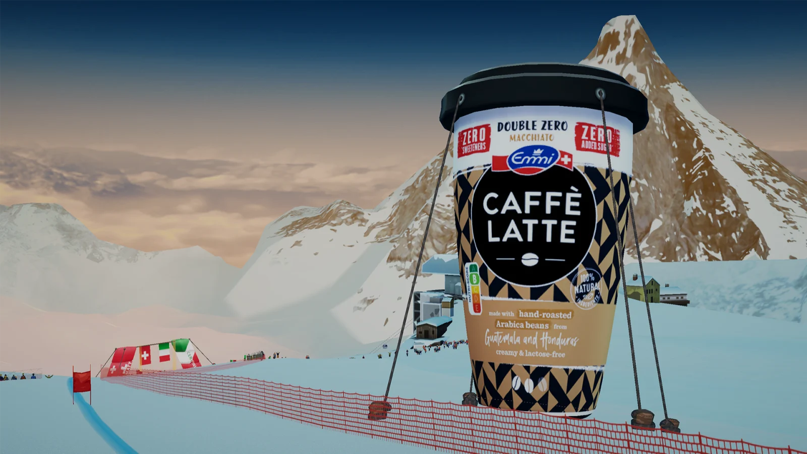 An oversized Emmi Caffè Latte cup beside the course and mountain